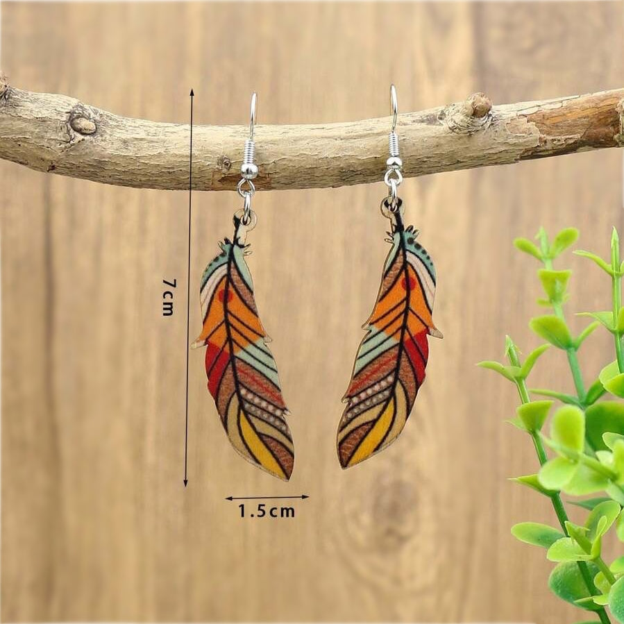 A pair of boho wooden feather earrings with a colorful tribal pattern, hanging from a tree branch with measurements indicating 7cm length and 1.5cm width.