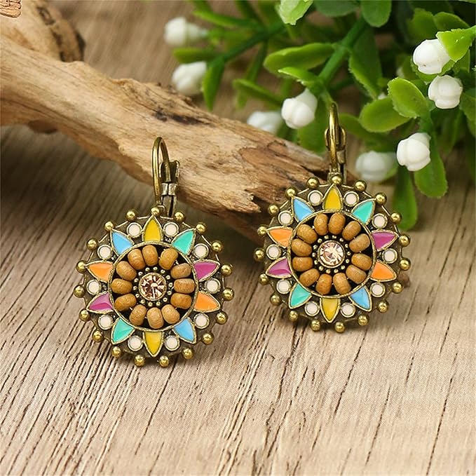 Another close-up of a single boho earring, highlighting the texture of the wooden beads and the vibrant colors of the enamel in its floral design.