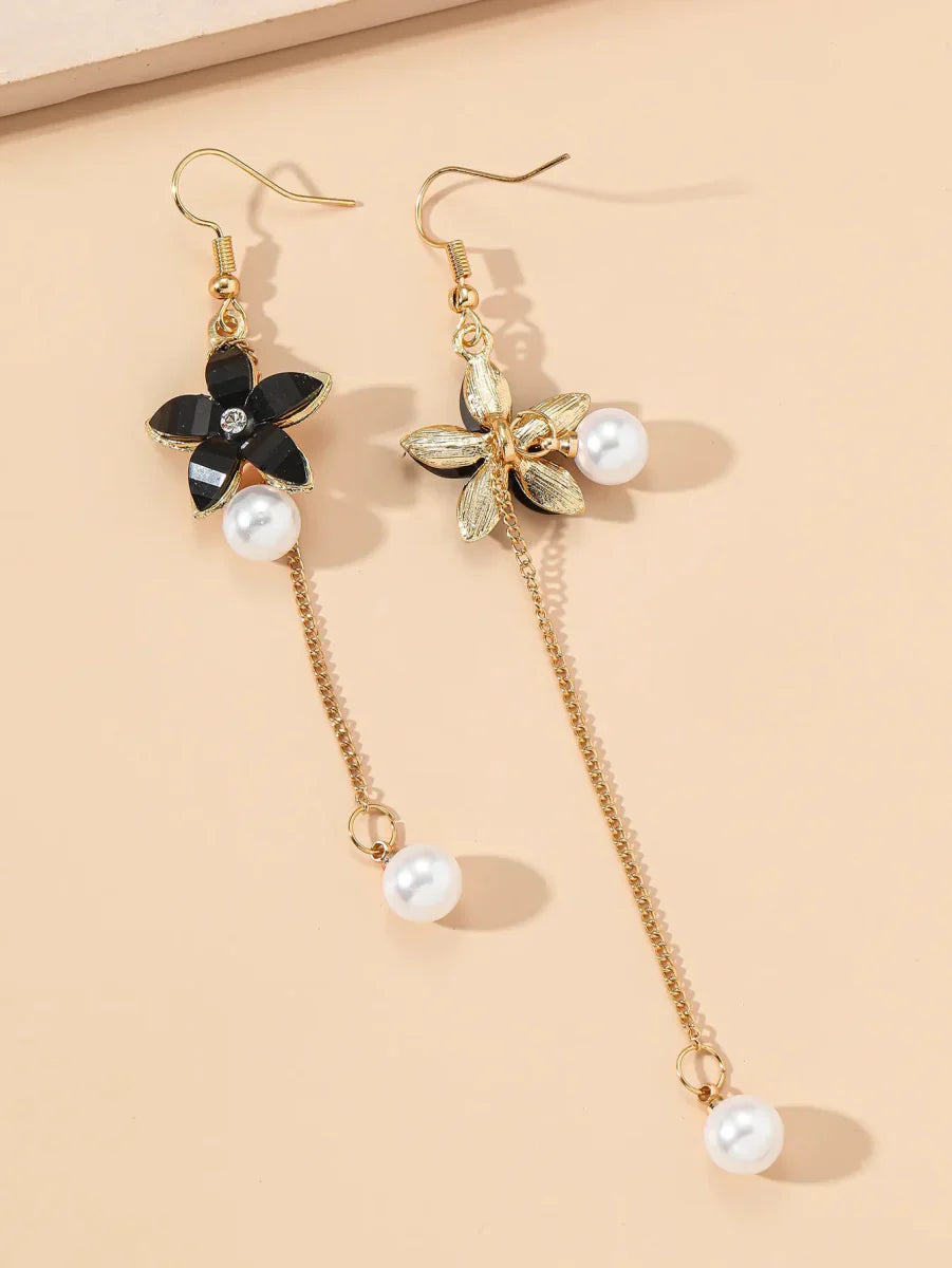 Pair of black floral long earrings with pearl chain dangle, one earring showing the back of the floral design.