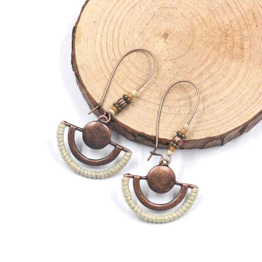 A close-up of the three pairs of boho earrings on a display card, showing intricate details of the oxidised metal, beads, and tassels.