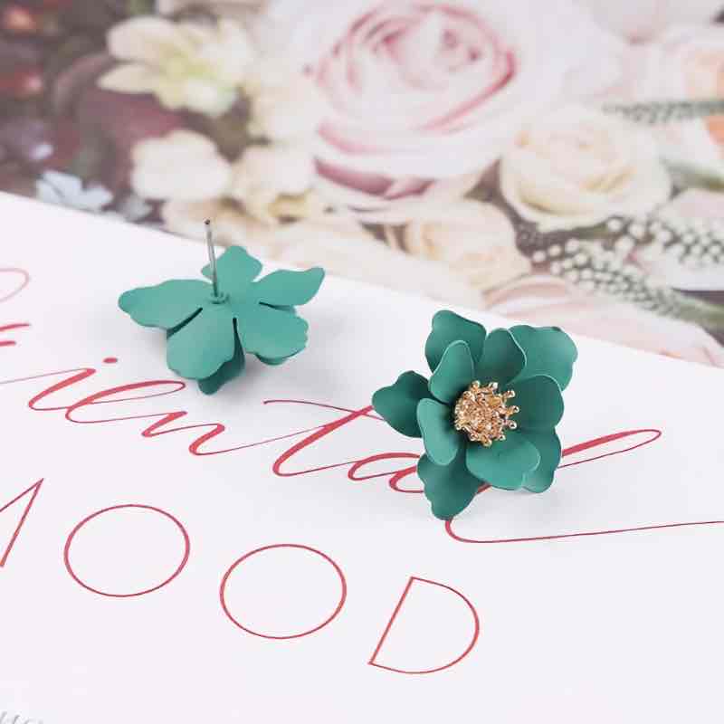 A pink Korean flower stud earring with a golden center.