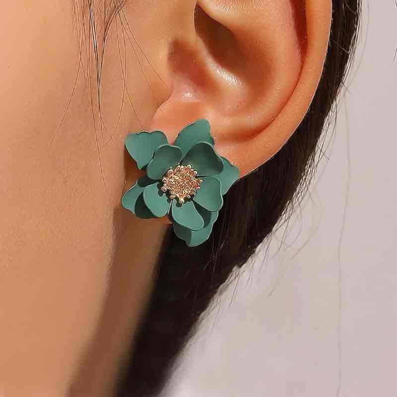 A navy blue Korean flower stud earring with a golden center.