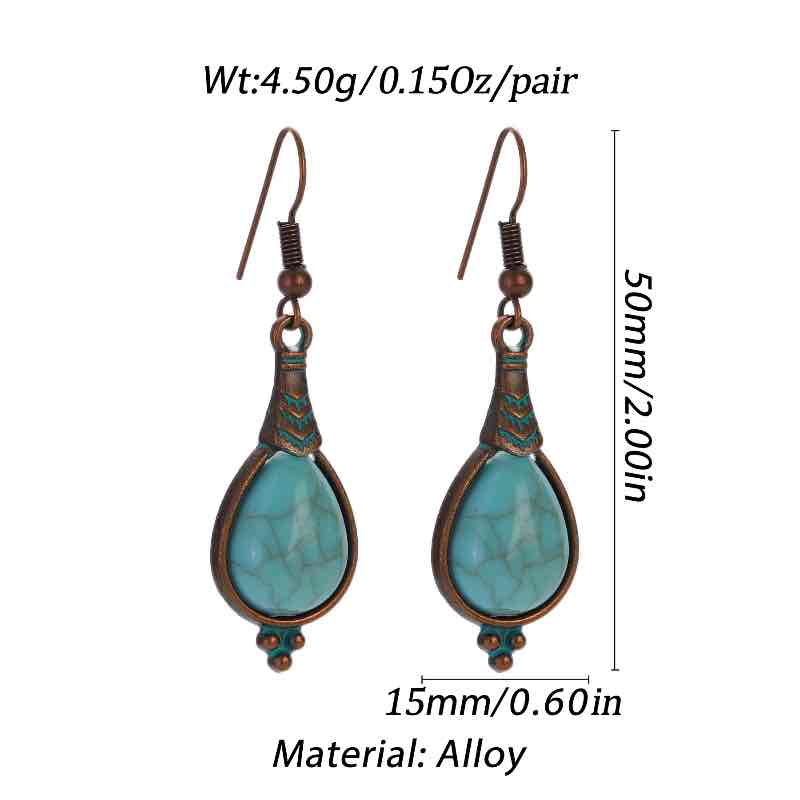 Close-up of two oxidised alloy teardrop turquoise stone drop earrings, showing the detail of the metalwork and the natural patterns in the turquoise.