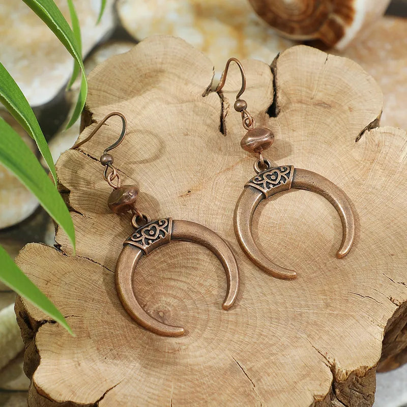 Unique oxidised crescent dangle earrings with antique bronze finish and etched detail - Front view | Earthy Origin