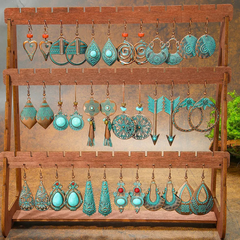 A display stand showcasing various styles of oxidised earrings, including the heart-shaped boho earrings, against a natural background.