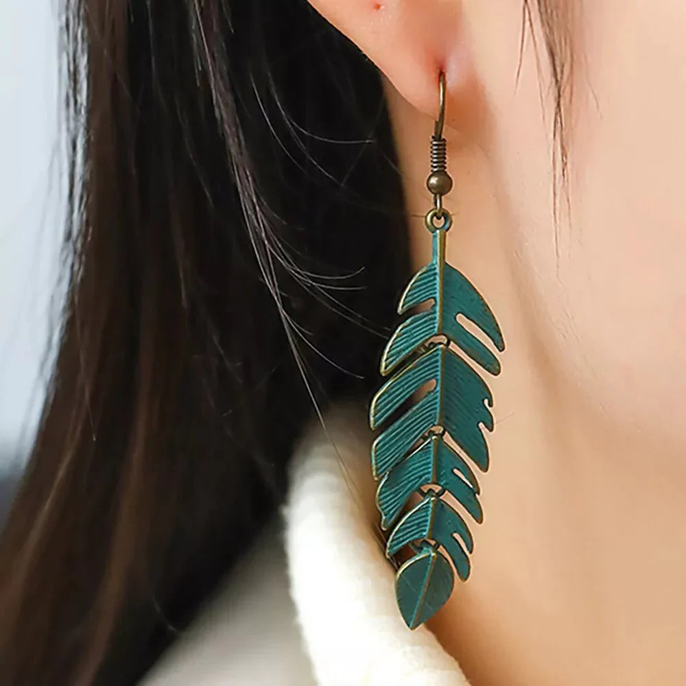 Small oxidised leaf earrings in teal - close-up | Earthy Origin