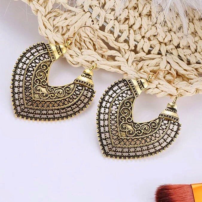 Close-up of an ornate oxidised drop earring showcasing intricate scrollwork and antique finish - detail view | Earthy Origin