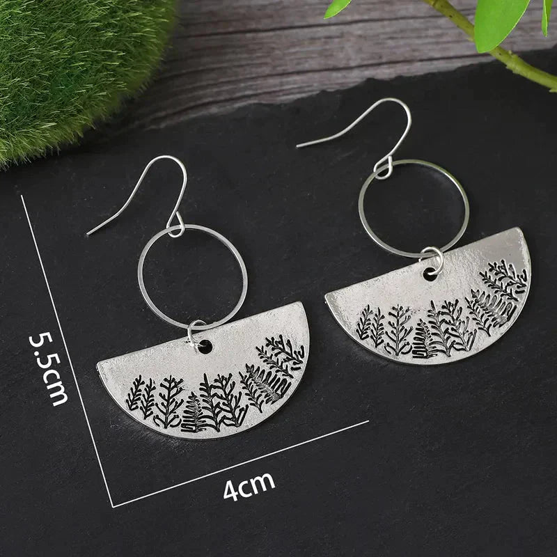 A close-up of the forest fern pattern on an oxidised earring.